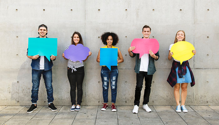 Group of teenagers holding speech bubbles